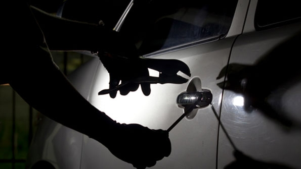 thief breaking into vehicle