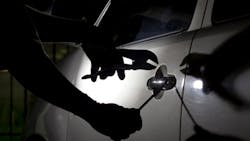 thief breaking into vehicle thief breaking into vehicle