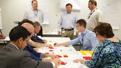 Faurecia employees participating in the FES Game, part of the company&apos;s orientation day activities. The game groups people together and helps them learn more about the Faurecia Excellence System (FES) and its role within the company.