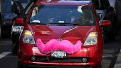 A Lyft car with the company39s trademark pink mustache A Lyft car with the company39s trademark pink mustache