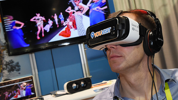 A CES attendee wears a Samsung Gear VR headset