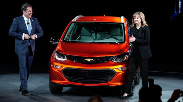 GM CEO and chairman Mary Barra, right, and EVP of global product development Mark Reuss show off the new Chevy Bolt at the North American International Auto Show in Detroit.