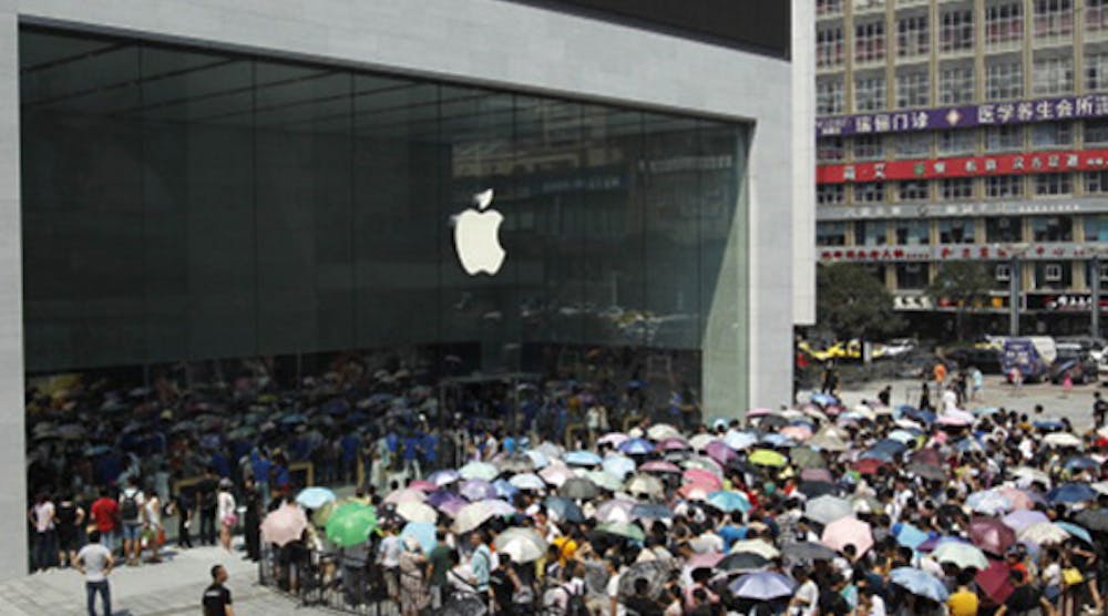Apple fans wait outside the first Apple store in Chongqing, China, in July 2014.
