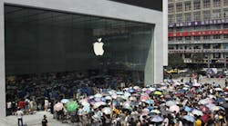 Apple fans wait outside the first Apple store in Chongqing, China, in July 2014.