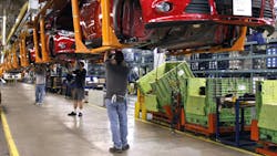 Ford workers on the assembly line in Wayne Michigan Ford workers on the assembly line in Wayne Michigan
