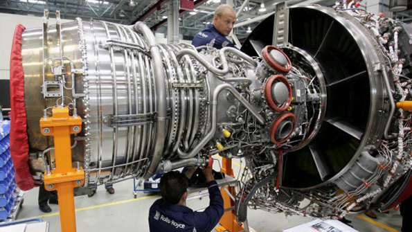 Workers assemble an engine at the RollsRoyce aircraft factory in Berlin