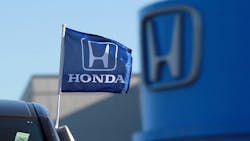 Honda logo on a flag and dealership sign Honda logo on a flag and dealership sign
