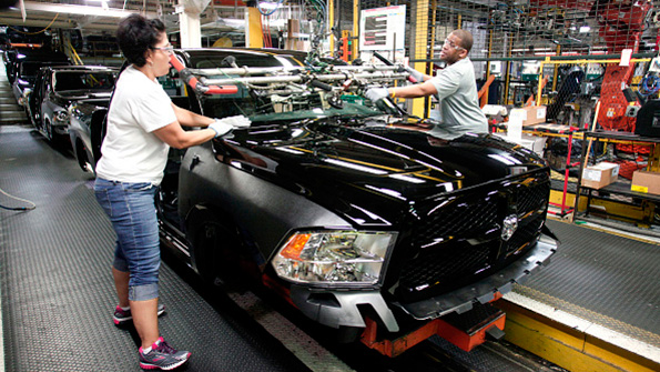 Chrysler workers install a windshield in a Ram 1500 truck in Warren Michigan