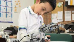A boy plays with the Lego prosthetic arm A boy plays with the Lego prosthetic arm