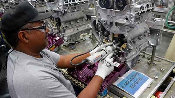 Operating technician Stevie Cater works on an engine at GM Spring Hill