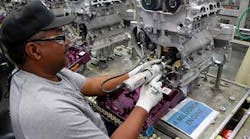 Operating technician Stevie Cater works on an engine at GM Spring Hill.