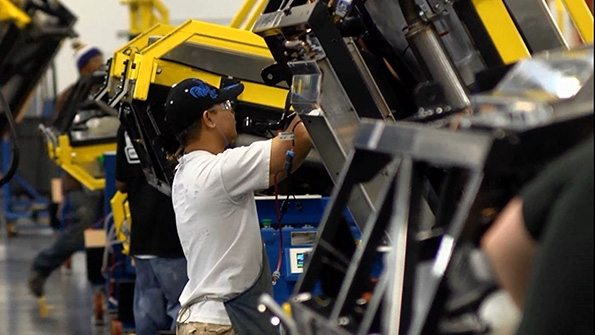 Carrier Transicold operator installing component on the trailer line where units can be rotated 360 degrees for optimum ergonomic positioning for the operator