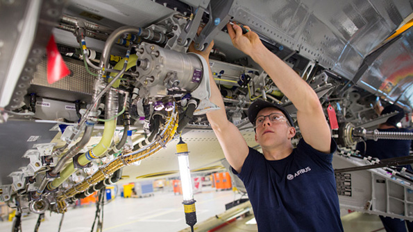 An Airbus fitter works on an A400M spoiler at the companys Bristol plant