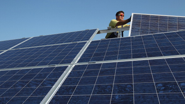 A German worker installs solar panels