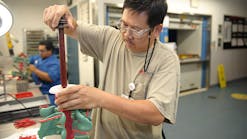 DePuy Synthes employees perform wax injection assembly for foundry casting.
