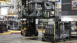 A forklift driver moves the racks of Jeep Cherokee body side panels at the FCA Sterling Stamping Plant.