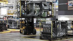 A forklift driver moves the racks of Jeep Cherokee body side panels at the FCA Sterling Stamping Plant A forklift driver moves the racks of Jeep Cherokee body side panels at the FCA Sterling Stamping Plant