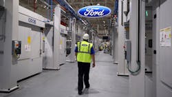 A worker walks through a British Ford plant A worker walks through a British Ford plant