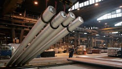A worker arranges billets of aluminum at a Hungarian Alcoa factory A worker arranges billets of aluminum at a Hungarian Alcoa factory