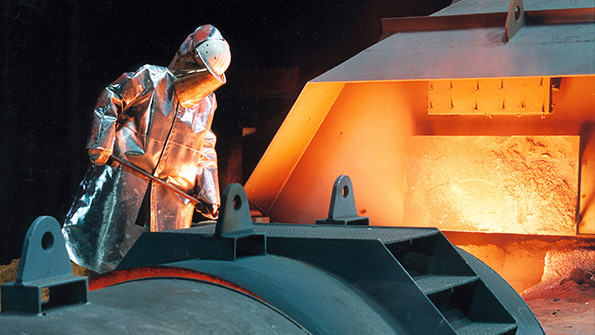 A worker tends to steel production at ThyssenKrupps Duisberg plant