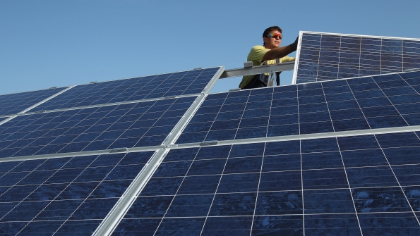A German worker installs solar panels