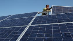 A German worker installs solar panels A German worker installs solar panels