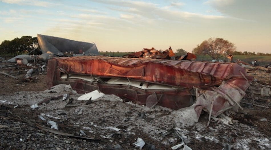 A railroad boxcar filled with ammonium nitrate lay on its side near to the remains of the fertilizer plant that exploded in 2013.