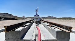 A recovery vehicle and a test sled sit on rails after the first test of the propulsion system at the Hyperloop One Test and Safety site on Wednesday in Nevada. The company says a fully operational hyperloop system will be out in the world by 2020.
