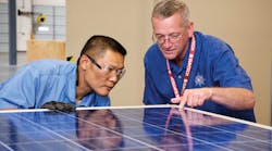 Employees inspect a solar panel as part of Suntech&rsquo;s quality control program. Once fully assembled, all Suntech modules undergo a final performance test and are categorized based on power and current production. Photo courtesy of SunTech America
