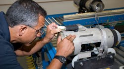 A Lockheed Martin team member applies sealant to a Javelin missile body A Lockheed Martin team member applies sealant to a Javelin missile body