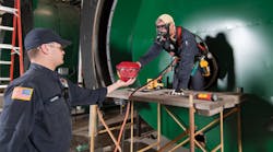 Dow Corning loss prevention officers perform pre-entry atmospheric testing and inspection of a confined space at the company&apos;s manufacturing plant in Midland, Mich.