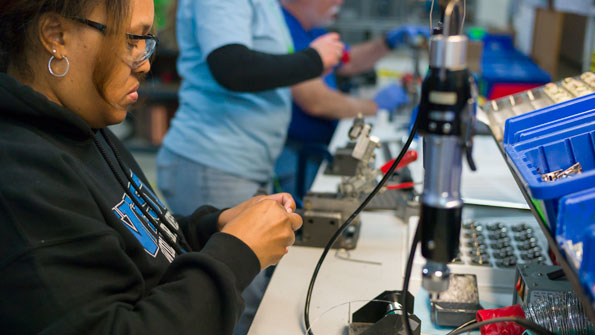 TLX employee solders parts in Wisconsin plant