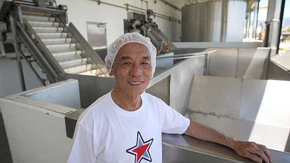 Huy Fong Foods CEO David Tran poses next to hoppers where chilies are delivered during chili crushing season at the Sriracha Hot Chili Sauce factory in Irwindale Calif Copyright David McNew Getty Images