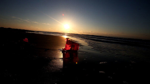A pail lays on its side as the sun rises on the Louisiana coast on April 19 2014 in Grand Isle This was taken days after BP announced it had concluded its 39active39 cleanup efforts Copyright Sean Gardner Getty Images
