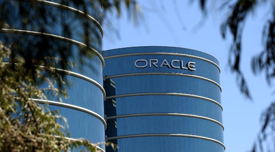 The Oracle logo is displayed on the exterior of the Oracle headquarters in Redwood Shores, California.