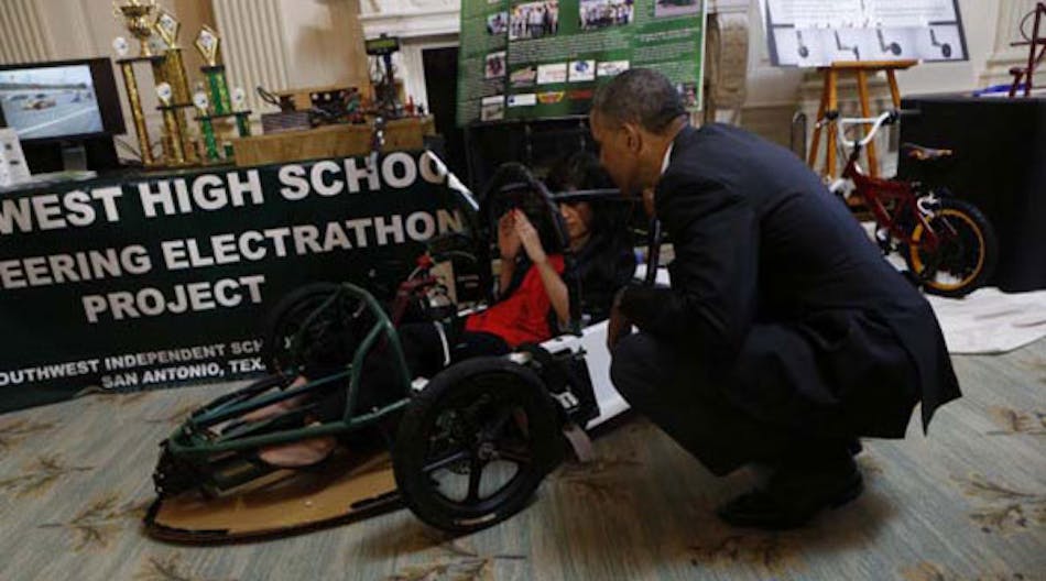 President Barack Obama talks with Deidre Carrillo of San Antonio, Texas, about her electric car project during the 2014 White House Science Fair on May 27. The annual event recognizes student achievements in science, technology, engineering and math competitions from across the United States. (Photo by Aude Guerrucci-Pool/Getty Images)