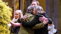 Grieving relatives console each other during a national memorial service Aug. 7 as Australians mourn the loss of all victims of Malaysia Airlines Flight MH17.