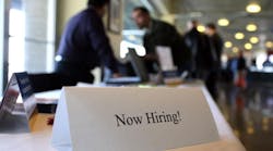 A &apos;Now Hiring&apos; sign is posted on a table during a recent Recruit Military Career Fair at AT&amp;T Park in San Francisco, California. (Photo by Justin Sullivan/Getty Images)