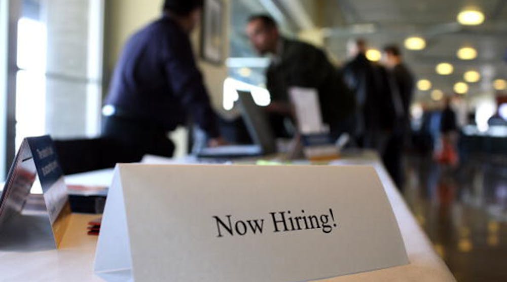 A &apos;Now Hiring&apos; sign is posted on a table during a recent Recruit Military Career Fair at AT&amp;T Park in San Francisco, California. (Photo by Justin Sullivan/Getty Images)