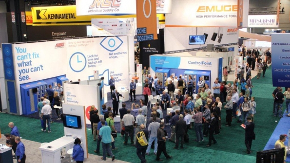 Attendees at the 2014 IMTS trade show crowd the booth of MSC Industrial Supply a company with deep roots in metalworking and manufacturing
