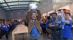 Patrick Tuntland holds up his new iPhone 6 Plus as he leaves an Apple Store on September 19, 2014 in Palo Alto, California.