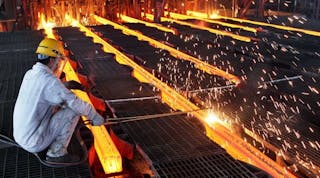 A worker cuts steel billets at an iron and steel enterprise in Ganyu County, China.