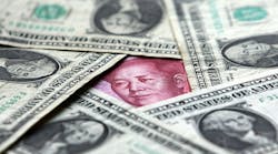 A yuan note is surrounded by U.S. dollars. While the U.S. Treasury says China&apos;s currency remains undervalued, it did comment on &apos;renewed willingness by authorities to allow the exchange rate to strengthen.&apos;