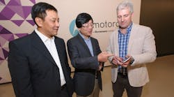 From left, Lenovo Executive VP Liu Jun, Lenovo CEO Yang Yuanqing and Motorola Mobility COO Rick Osterloh celebrate the closing of Lenovo&apos;s acquisition of Motorola Mobility today in Chicago. (Photo by Timothy Hiatt/Getty Images for Motorola)