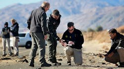 Agents from the National Transportation Safety Board, FBI and sheriff&apos;s office comb through the wreckage of the Virgin Galactic SpaceShip 2 in a desert field Nov. 2, 2014, north of Mojave, Calif.