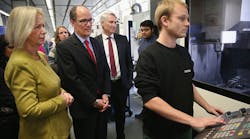 U.S. Labor Secretary Thomas Perez, center, and German Education Minister Johanna Wanka watch as trainee Til Pagenkopf demonstrates the use of a CNC machine at the Siemens training facility in Berlin, Germany, on October 28. Perez visited the center to learn more about the German trainee system, in which manufacturers offer paid multiyear training programs to recent high school graduates. (Photo by Sean Gallup/Getty Images)