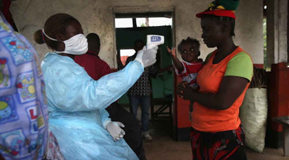 A Liberian Ministry of Health worker checks people for Ebola symptoms at a checkpoint near the international airport on August 24, 2014, near Dolo Town, Liberia. (Photo by John Moore/Getty Images)