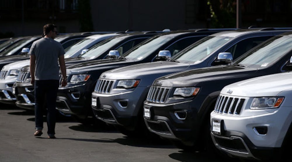A customer looks at brand new Jeeps that are displayed on the sales lot at Chrysler Jeep Dodge Ram Marin in Corte Madera, California, on September 3. (Photo by Justin Sullivan/Getty Images)