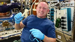 ISS Commander Butch Wilmore holds up the ratchet after removing it from the print tray.