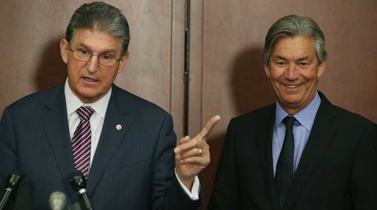 U.S. Sen. Joe Manchin (D-W.V.) (L) speaks while flanked by Canadian Ambassador to the United States Gary Doer during a news conference on the Keystone XL pipeline, on Capitol Hill.